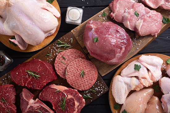 Image of different cuts of raw beef, chicken, and pork. 